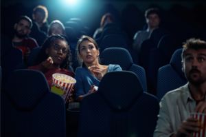 Two girls watching a movie in a movie theatre to show TS Media Group Video Production Services in Jupiter Florida